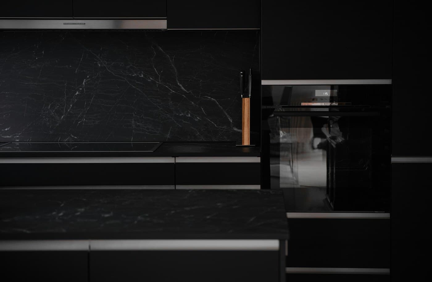 Cocina moderna con electrodomésticos negros y mármol